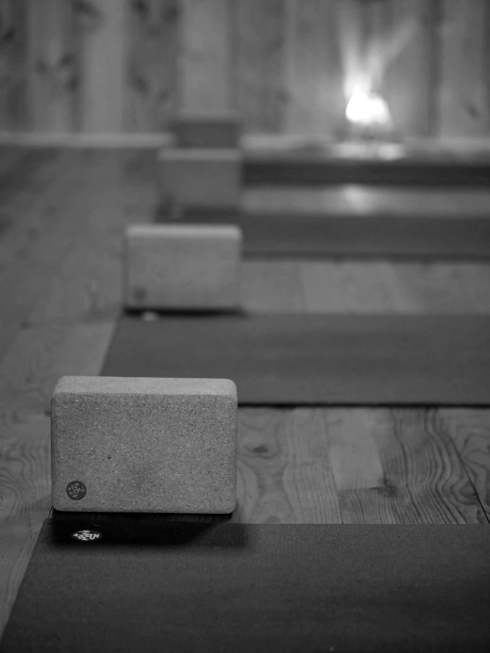 a row of yoga mats sitting on top of a wooden floor